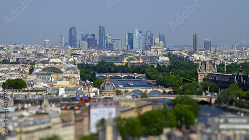 Panoramic Paris cityscape with the modern La Défense business district visible in the distance.