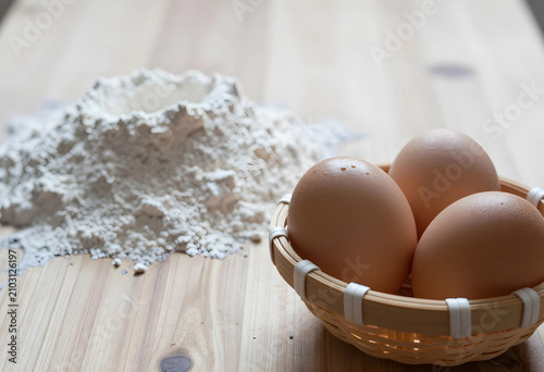 Three fresh brown eggs in a...