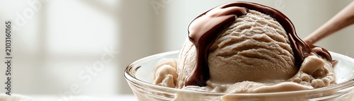 Delicious ice cream topped with chocolate sauce.