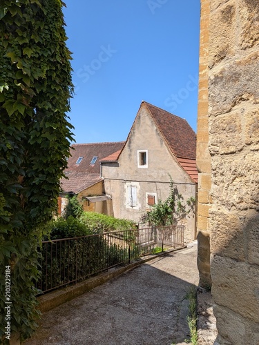Bild auf Leinwand Charming viewpoint along a narrow paved path overlooking traditional stone house