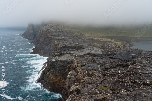 Rocky Coastline Where Bosdalafossur Waterfall Meets the Ocean, Faroe Islands