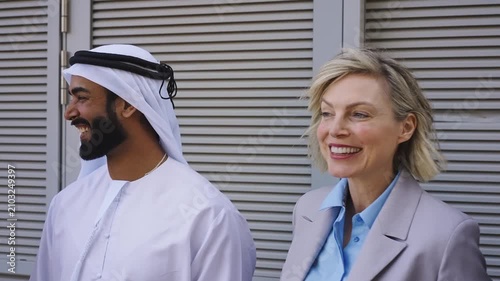 Group of multiethnic business people meeting an emirati businessman - International corporate business team bonding outdoors in the city