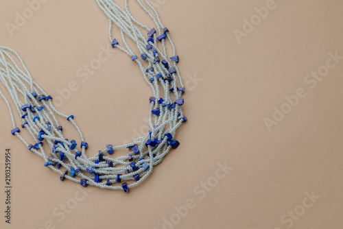 Obraz na płótnie Elegant Beaded Necklace with Azure Blue Stones on a Neutral Backdrop, Perfect fo