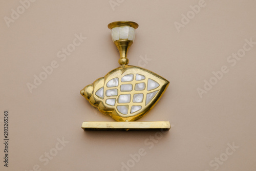 Obraz na płótnie Elegant golden wall sconce with shell inlay details, a luxurious decorative ligh