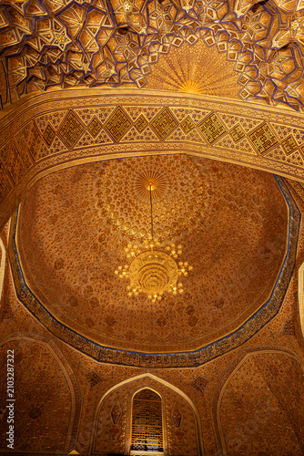 Ceiling and interior of Gur-e-Amir mausoleum in golden colour, Samarkand.