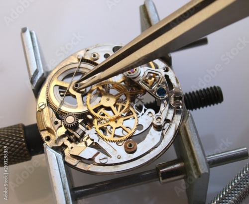 Macro photography concept of internal mechanism and vintage gears of a mechanical watch under repair