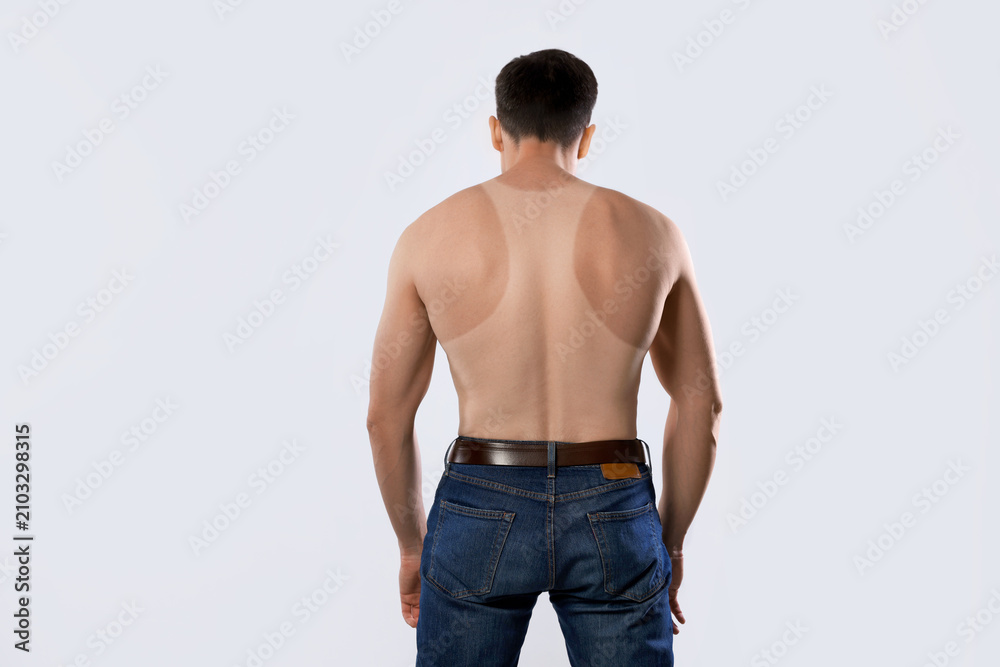 Obraz premium Man with suntan lines left after wearing sleeveless shirt, back view. White background