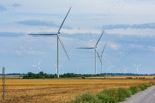 Wind turbines at the agricultural field. Clean energy. Ecological concept