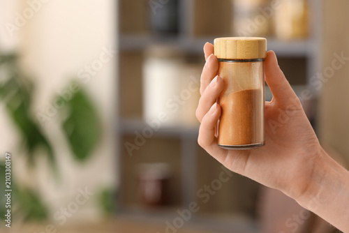Hand holding a glass spice ...