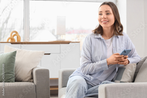 Young woman using mobile ph...