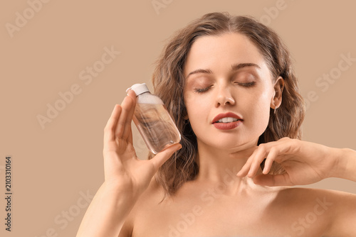 Young woman with bottle of ...