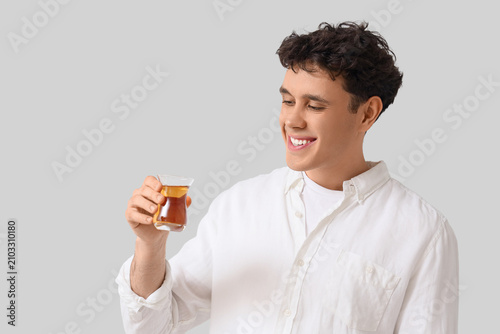 Young man with Turkish tea ...