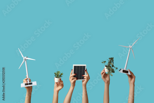 Many hands with wind turbin...