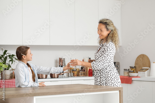 Happy mother giving glass o...