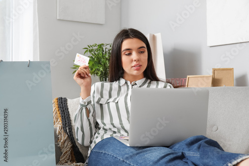 Young woman with gift card ...