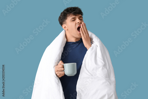 Handsome young man with cup...