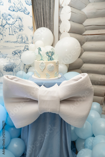 Blue And White Themed Cake With Balloons In Decorated Room