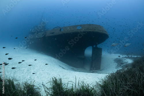 Photography MV Rozi Shipwreck resting on sandy seabed in clear blue water in the Mediterranean sea in Malta