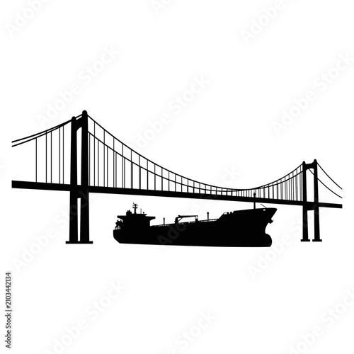 Large oil tanker ship passing under suspension bridge silhouette