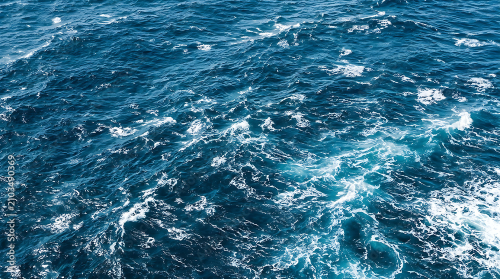 Fototapeta premium Turquoise ocean waves crashing in open sea.