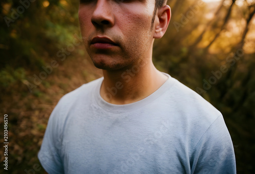 Close-up of young man in white t-shirt outdoors