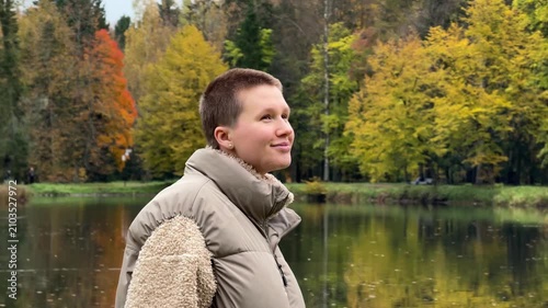 man in park looking around and smiling, relaxed and happy, autumn foliage, casual attire, side view, commercial natural light, clean background, copy space, editorial resource, web banner.