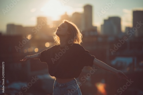 Freedom in urban sunset silhouette