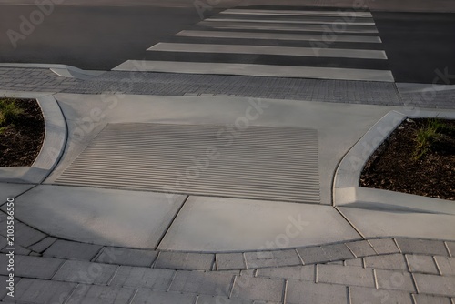 Wheelchair Curb Ramp Meets Smooth Pedestrian Crossing Seamlessly Highlighting Safe Accessible Urban Street Design Photography