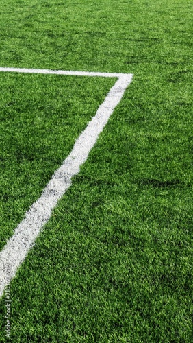 White angled line marking on green football turf