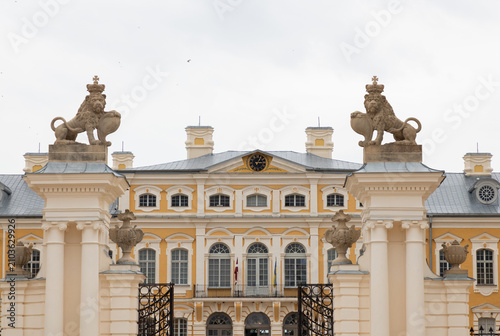 Obraz na płótnie Grand Baroque Palace Gate With Lion Statues, Ornate Columns, Clock Pediment and
