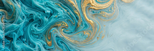 Ink marbling on water surface swirls of turquoise and shimmering gold paint art photo
