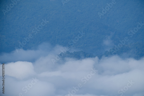 Breathtaking aerial view of misty valleys and lush green tropical rainforest mountains at dawn