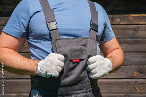 Bild auf Leinwand Male industrial worker in overalls and protective gloves