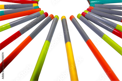 Colorful wooden pencils arranged in a circular pattern create a vibrant display of artistic tools against a solid white background.