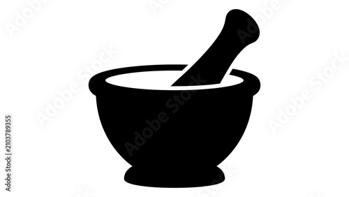 Mortar and pestle are used for grinding herbs in a traditional apothecary or kitchen setting.
