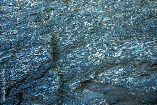 View of textured rock surface with blue and gray hues Emerald slate close up