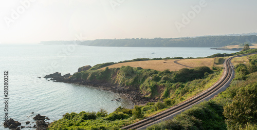 Tableau sur toile Beautiful Devon coastline with a train track winding across the frame
