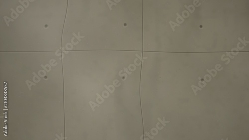 Tableau sur toile Concrete wall with grid pattern and circular indentations