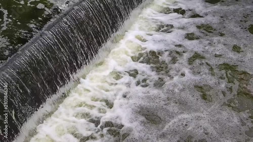 Turbid water flow. Rapid flow mountain river. Dirty stream flooding