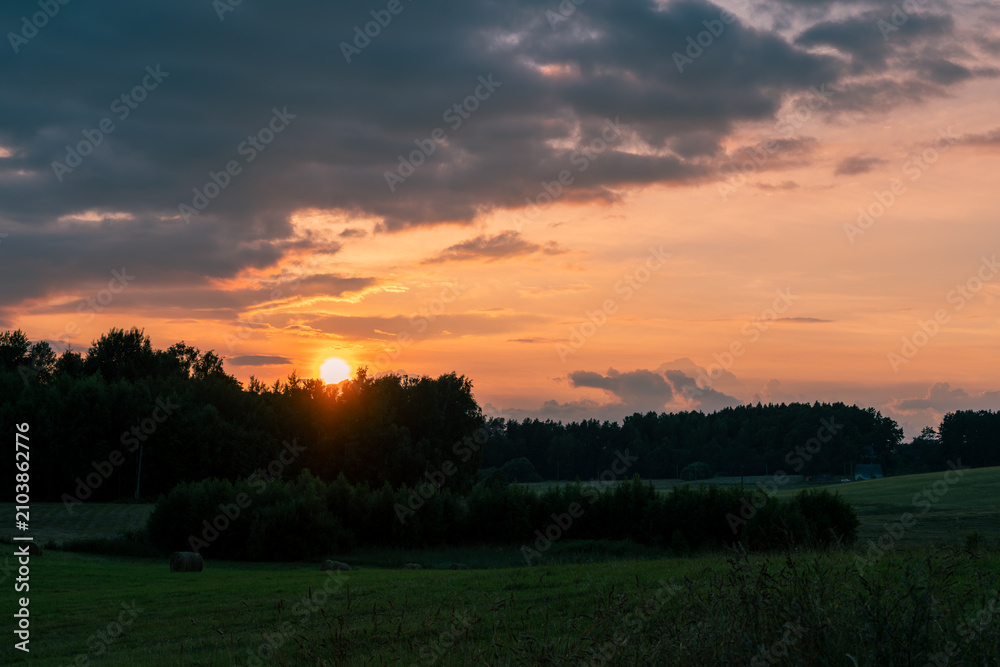 Obraz premium Colorful Summer Sunset Clouds Over the Meadows of Latgale, Latvia