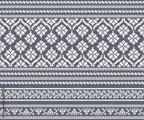 A seamless horizontal pattern featuring various floral and decorative motifs in white tones against a gray geometric background; designed for fabrics, clothing, backgrounds, and decoration.