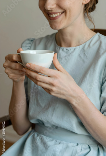 Smiling woman holding a whi...