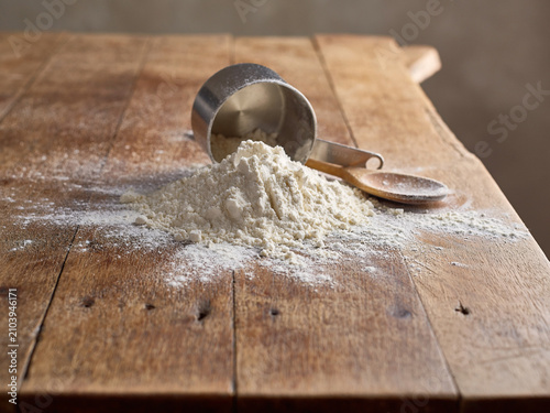 Spilled flour on a wooden table, pastries food, raw material