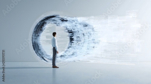 A businessman stands in front of a brightly lit computer portal full of data and information.