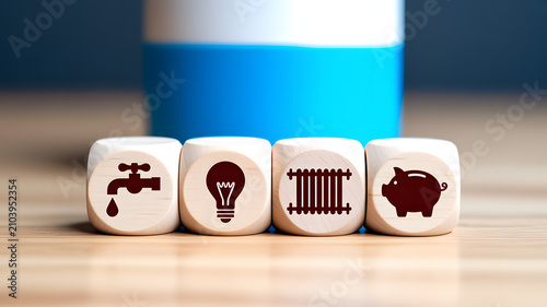 Four wooden cubes with for water light radiator and piggy bank dice water tap dripping water light bulb