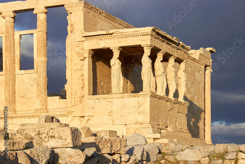 Bild auf Leinwand Ancient Caryatid statues of the Erechtheion temple under a dramatic stormy sky,