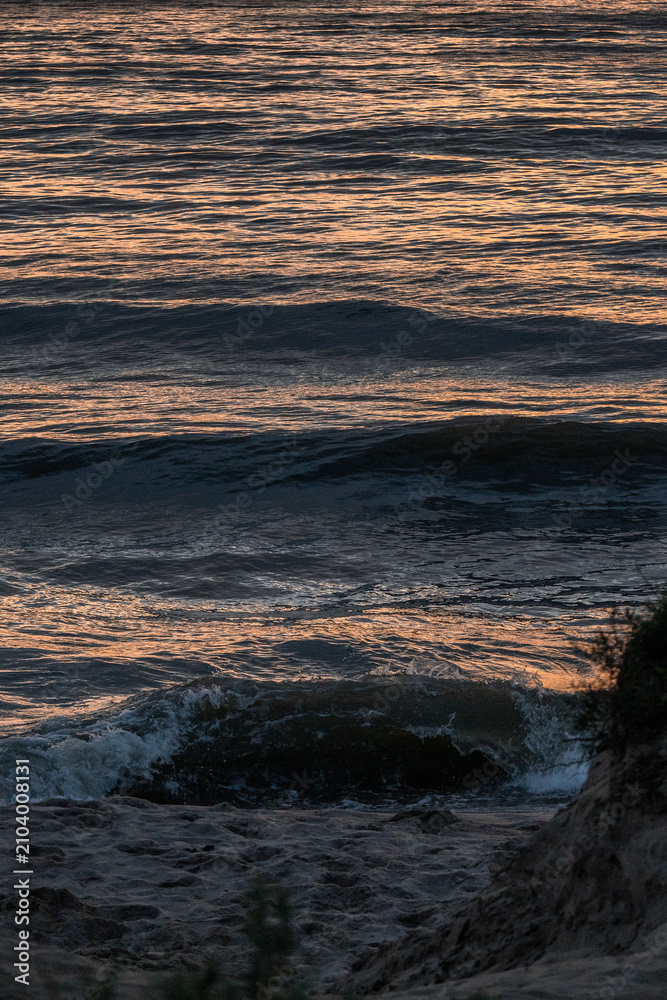 Fototapeta premium Waves in the Baltic Sea at sunset in summer