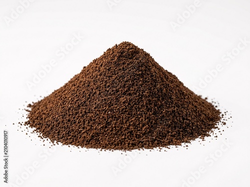 Pile of dark brown ground coffee powder isolated on a clean white background