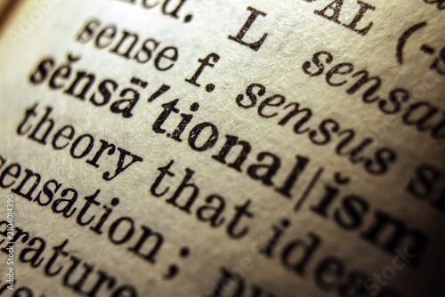 Konstfotografi Word sensationalism on dictionary page, macro close up