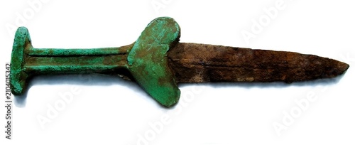 Konstfotografi Macro shot of ancient bimetallic dagger hilt with green bronze patina and rusty iron blade isolated on white background